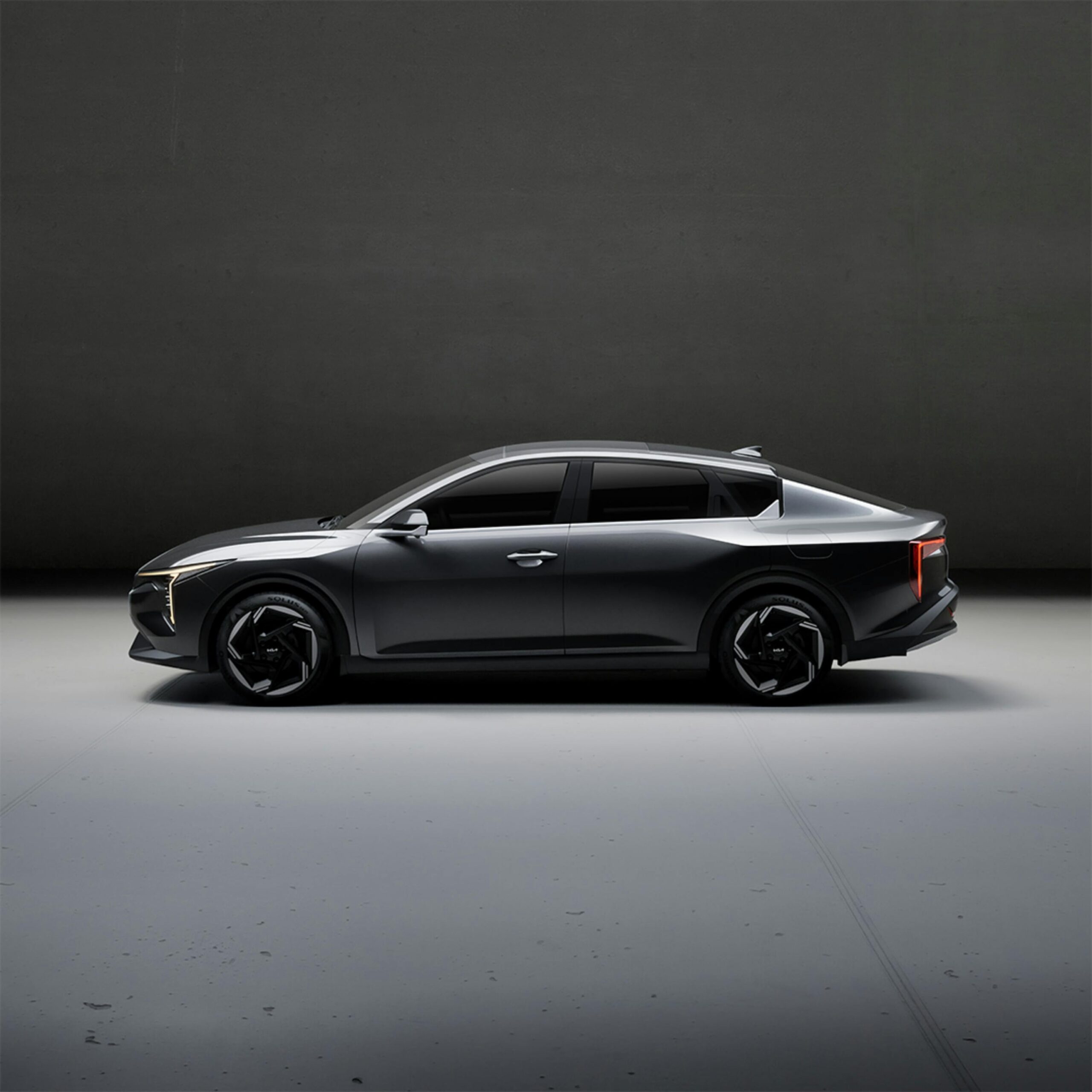 Sleek electric car showcased in a minimalist indoor studio setting, highlighting design and innovation. Car has window tinting.